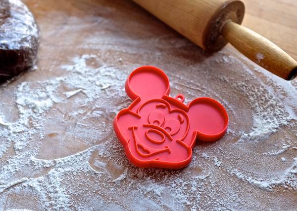 vintage mickey mouse cookie cutter on a cutting board