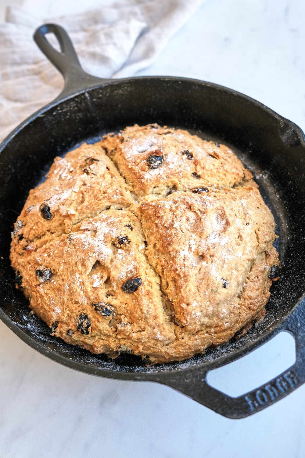 A loaf of irish soda bread in an iron skillet
