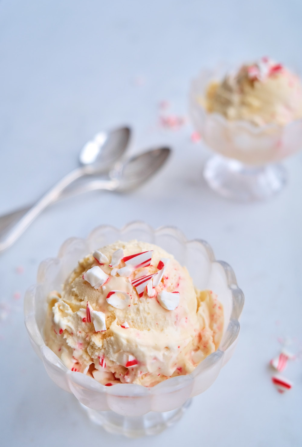 A bowl of peppermint stick ice cream with crushed candy canes on top.